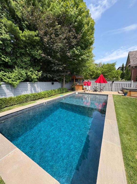 Backyard pool with dark membrane